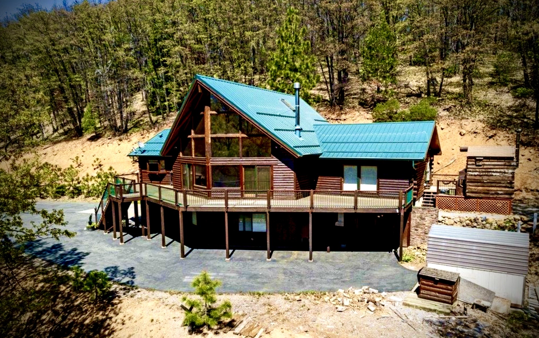 Side view of the cabin set into the forested hillside