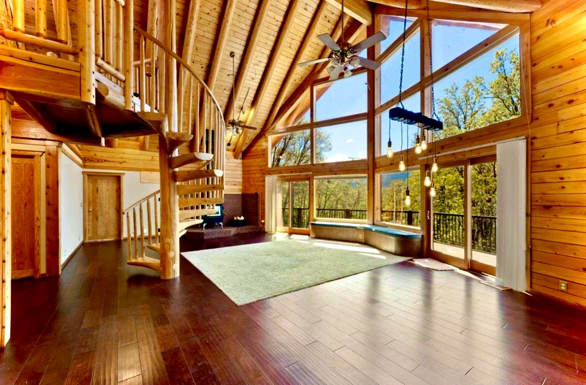 Spiral staircase and floor-to-ceiling windows in the great room