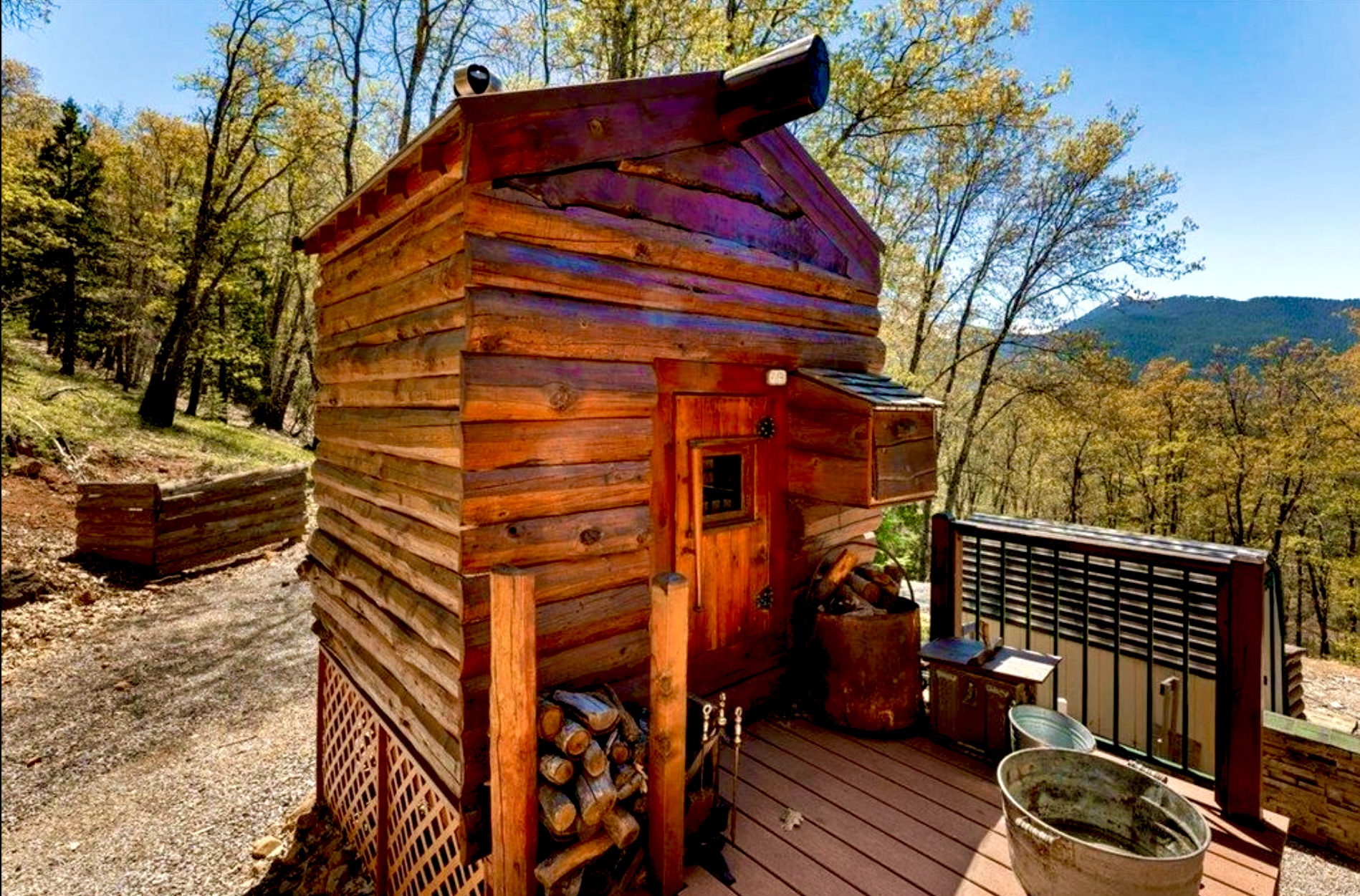 Cedar wood-fired sauna on the cabin deck overlooking the mountains
